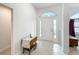 Bright foyer with arched windows and tile flooring showcases a charming decorative table at 153 Heritage Park Ln, Mulberry, FL 33860