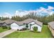 Charming home featuring a lush green lawn, attached two car garage, and inviting curb appeal at 153 Heritage Park Ln, Mulberry, FL 33860