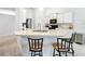 Kitchen featuring sleek countertops, stainless steel sink, and barstool seating at the breakfast bar at 153 Heritage Park Ln, Mulberry, FL 33860