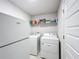 The laundry room features a washer, dryer, storage and provides convenience for laundry tasks at 153 Heritage Park Ln, Mulberry, FL 33860