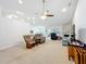 Open living area with neutral carpet, ceiling fan, stone fireplace, and backyard access at 153 Heritage Park Ln, Mulberry, FL 33860