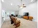 Spacious living room featuring carpet, stone fireplace, neutral paint colors, and abundant natural light at 153 Heritage Park Ln, Mulberry, FL 33860