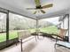 Relax on this screened patio with ceiling fan and enjoy the outdoor scenery at 153 Heritage Park Ln, Mulberry, FL 33860