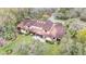 Aerial view of large home with surrounding green space and patio area at 159 Coventry Cir, Haines City, FL 33844