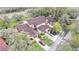 Angled aerial view of the home, showing multiple garages and manicured lawn at 159 Coventry Cir, Haines City, FL 33844