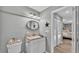 Bathroom featuring a granite countertop, modern mirror, a toilet, and decorative accents at 159 Coventry Cir, Haines City, FL 33844