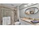 Bathroom featuring a glass door shower, granite countertops, a modern mirror, and decorative accents at 159 Coventry Cir, Haines City, FL 33844