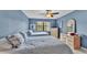 Charming bedroom with two beds, window view, ceiling fan, and light wood furniture at 159 Coventry Cir, Haines City, FL 33844