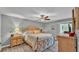 Comfortable bedroom featuring a ceiling fan, hardwood floors, a queen bed, and a neutral gray color scheme at 159 Coventry Cir, Haines City, FL 33844
