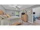Comfortable bedroom featuring a ceiling fan, hardwood floors, a queen bed, and access to an outdoor patio at 159 Coventry Cir, Haines City, FL 33844