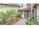 A cozy entrance with a brick path, lemon tree, and a charming front door at 159 Coventry Cir, Haines City, FL 33844