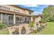 Back exterior of home featuring brick-paved patio and enclosed porch at 159 Coventry Cir, Haines City, FL 33844