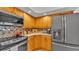 Well-lit kitchen featuring updated appliances, mosaic backsplash and wooden cabinets at 159 Coventry Cir, Haines City, FL 33844