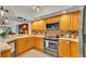 Well-equipped kitchen with stainless steel appliances and beautiful backsplash tiles at 159 Coventry Cir, Haines City, FL 33844