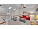 Bright living room with vaulted ceilings, skylights, red sofa, and comfortable armchair at 159 Coventry Cir, Haines City, FL 33844