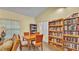 Inviting living room with a dining table, chairs, a comfortable seating area, and built-in bookshelves at 159 Coventry Cir, Haines City, FL 33844
