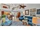 Bright living room boasts a vaulted ceiling, ceiling fan, an upstairs overlook, and comfortable seating at 159 Coventry Cir, Haines City, FL 33844
