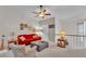 A cozy living room boasts a red sofa, stylish ottoman, and a ceiling fan for comfortable living at 159 Coventry Cir, Haines City, FL 33844