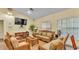 Comfortable living room features a plush sofa, cozy chairs, a large TV, and built-in bookcases at 159 Coventry Cir, Haines City, FL 33844