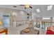 Open living room with vaulted ceilings, ceiling fan, and staircase view to other floors of home at 159 Coventry Cir, Haines City, FL 33844