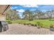 Brick-paved patio showcasing lovely green backyard and open sky at 159 Coventry Cir, Haines City, FL 33844