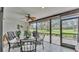 Enclosed porch with ceiling fan and lovely backyard views through expansive glass panels at 159 Coventry Cir, Haines City, FL 33844