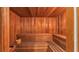 A beautiful wood-paneled sauna features built-in bench seating and a bucket and ladle at 159 Coventry Cir, Haines City, FL 33844