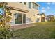 A view of the backyard featuring a brick patio and sliding glass doors to the home's interior at 168 Hampton Loop, Davenport, FL 33837