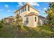 Lush green backyard featuring a well-maintained lawn and the home's exterior under a blue sky at 168 Hampton Loop, Davenport, FL 33837