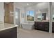A stunning bathroom featuring a large bathtub, stylish vanities, and a glass-enclosed shower at 168 Hampton Loop, Davenport, FL 33837