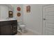 Modern powder room features a dark vanity, quartz countertop, and clean, bright space at 168 Hampton Loop, Davenport, FL 33837