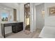 This bathroom features a spacious shower, stylish vanity, and a separate bathtub area at 168 Hampton Loop, Davenport, FL 33837