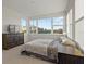 Sunlit bedroom featuring large windows, a dresser, and comfortable furnishings at 168 Hampton Loop, Davenport, FL 33837