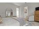 This bedroom includes a large mirror, accent chair, and view into a wardrobe area at 168 Hampton Loop, Davenport, FL 33837