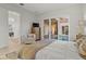 Bright bedroom with an armchair, TV, and views of the pool and outdoor area at 168 Hampton Loop, Davenport, FL 33837
