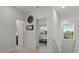 Bright hallway featuring neutral-colored walls and light-colored flooring, leading to various rooms at 168 Hampton Loop, Davenport, FL 33837
