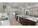 Open kitchen with dark wood island, white cabinets, and stainless appliances overlooking the pool at 168 Hampton Loop, Davenport, FL 33837
