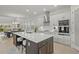 Gourmet kitchen with stainless appliances, white cabinets, island with seating and adjacent dining at 168 Hampton Loop, Davenport, FL 33837