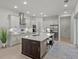 Spacious kitchen features stainless steel appliances, a center island with seating, and sleek cabinetry at 168 Hampton Loop, Davenport, FL 33837