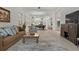 Open-concept living room features tile flooring, a modern media center and flows into the dining area at 168 Hampton Loop, Davenport, FL 33837