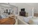 Bright living room features high ceilings, tile floors, and views into the dining and kitchen areas at 168 Hampton Loop, Davenport, FL 33837