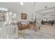 Bright living room with tall windows, neutral decor, and an open layout connected to the dining area at 168 Hampton Loop, Davenport, FL 33837