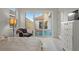 Bright primary bedroom with pool view, offering a serene retreat within the home at 168 Hampton Loop, Davenport, FL 33837