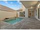 Private backyard pool featuring a small waterfall, ample patio space, and outdoor living at 168 Hampton Loop, Davenport, FL 33837