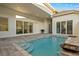 Inviting backyard pool area with a charming waterfall, creating a relaxing outdoor retreat at 168 Hampton Loop, Davenport, FL 33837