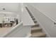 Bright staircase with carpeted steps and white handrail leading to the upper level of the home at 168 Hampton Loop, Davenport, FL 33837