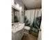Cozy bathroom with a leaf-themed shower curtain and decorative mirror at 1771 Bayview Dr, Lakeland, FL 33805