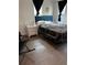 Bedroom with laminated flooring, a bed with a tufted headboard, and a nightstand at 1771 Bayview Dr, Lakeland, FL 33805