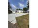 A one-story home featuring a large front yard and a spacious concrete driveway at 1771 Bayview Dr, Lakeland, FL 33805