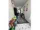 View of cluttered hallway with toys and decorations on the white walls at 1771 Bayview Dr, Lakeland, FL 33805